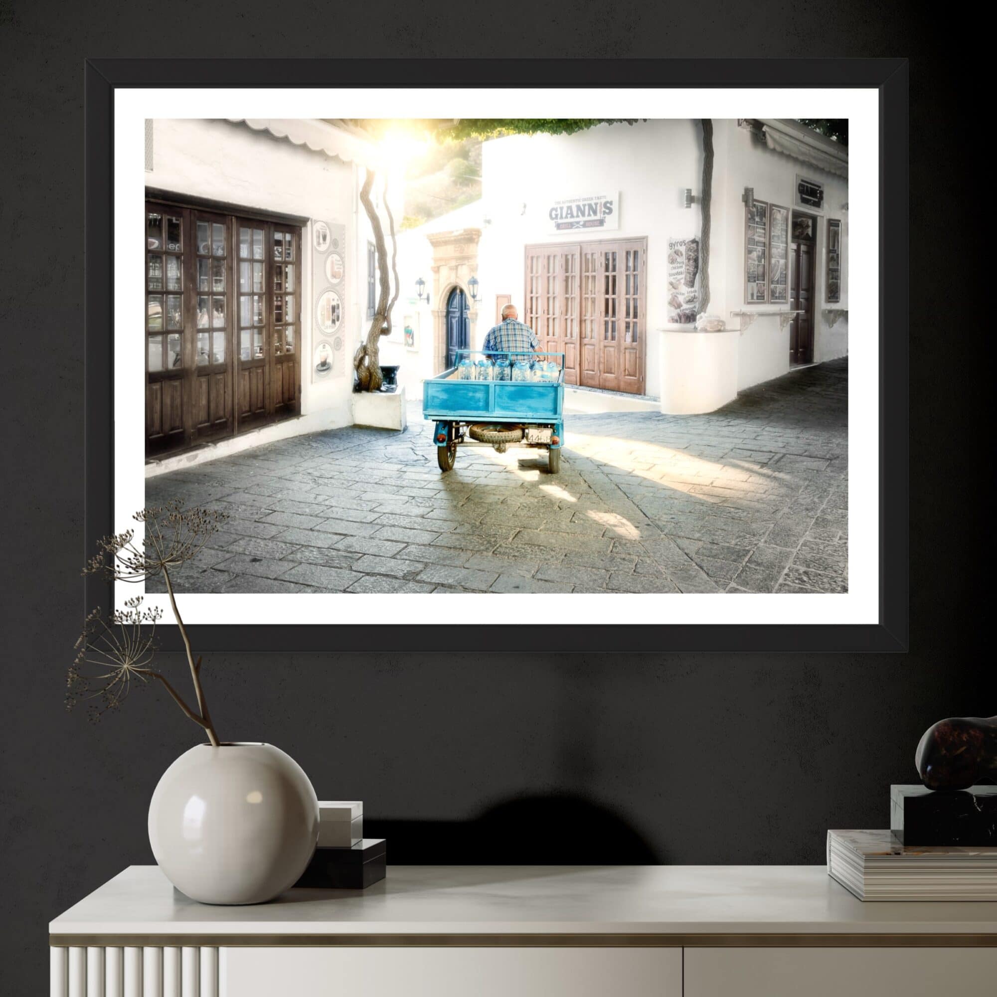 Aeonian Fine Art: Morning Deliveries Lindos shown as a hand-stretched canvas in a contemporary room setting.