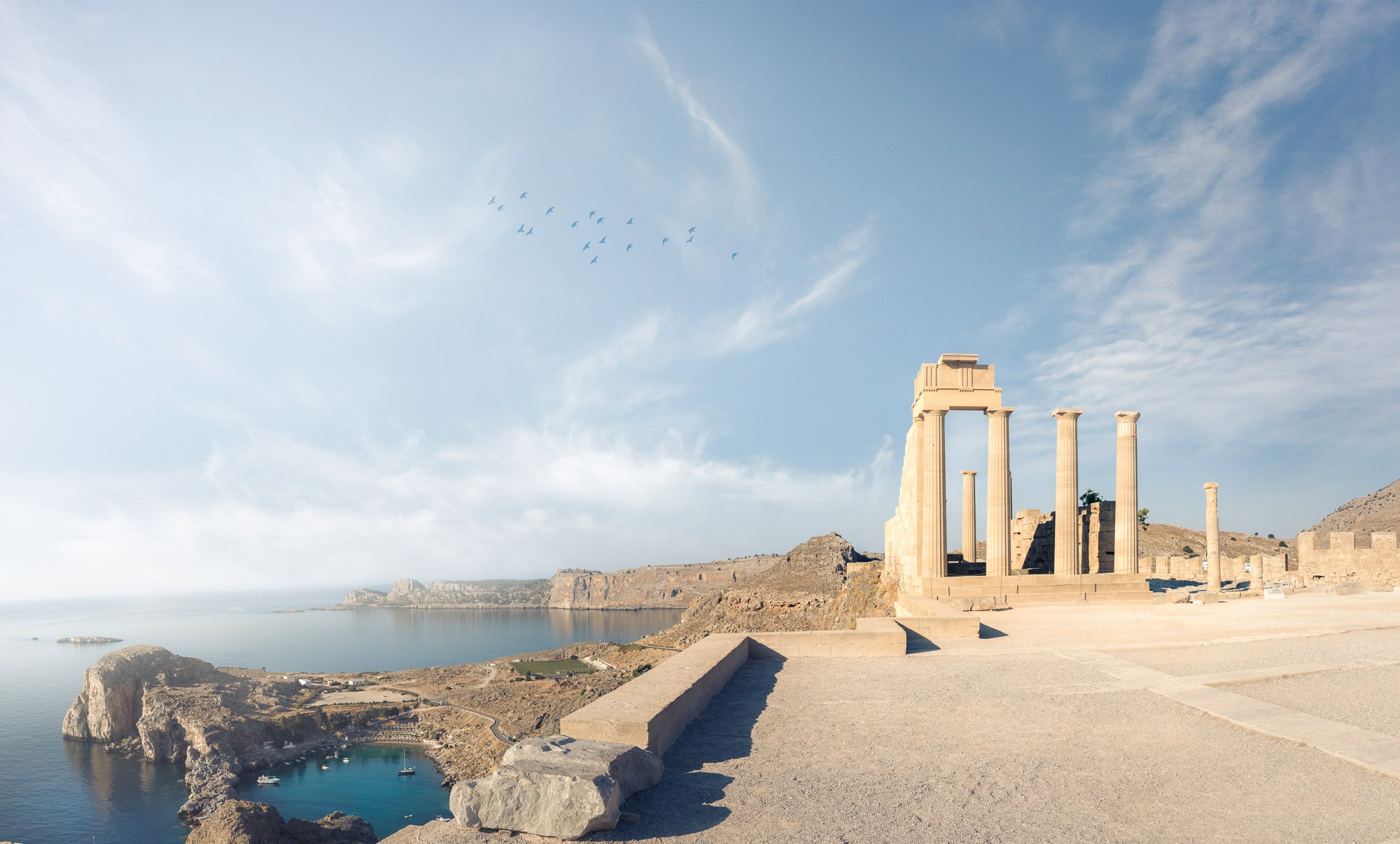 "The ancient Temple of Athena Lindia at the Acropolis of Lindos, Rhodes, bathed in crystal-clear morning light that emphasizes the historic textures of the pillars. This premium artwork is available as a museum-grade 100% cotton canvas or a Limited Edition Giclée print, both hand-finished with a 1.5-inch (3.8 cm) solid Latvian pine frame."