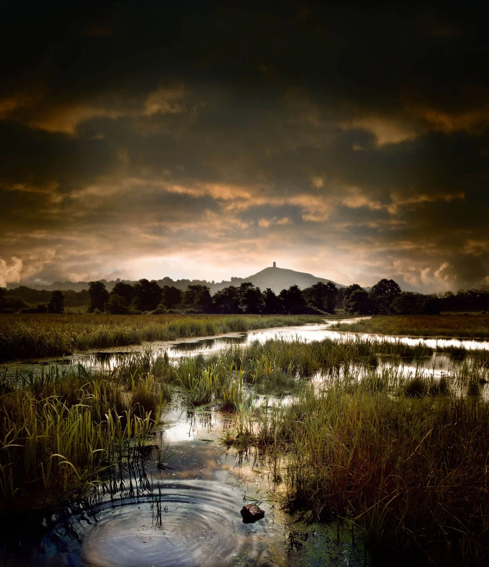 Glastonbury Tor Rises Above Ancient Flooded Marsh On The Somerset Levels